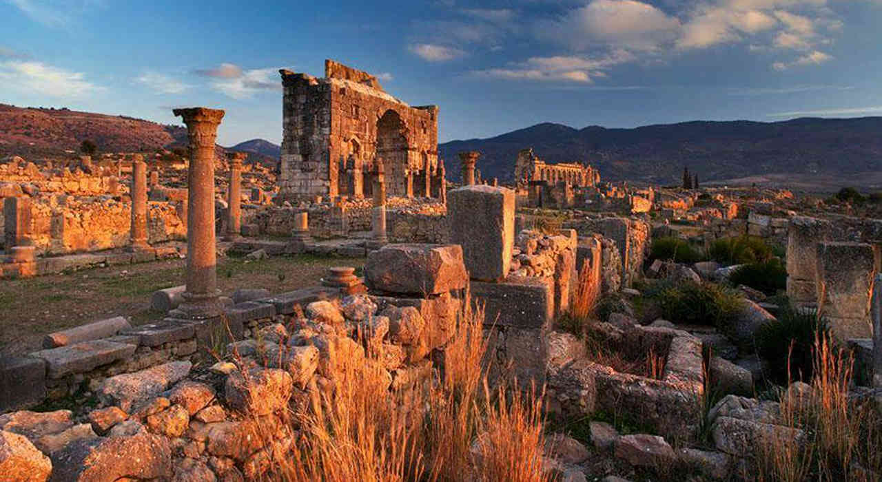 Sunset over the Romantic Roman Ruins of Volubilis and its Triumphal Arch Near to Meknes imperial city
